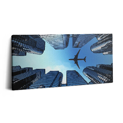Obraz na plátně 140x70 Letadlo nad budovami